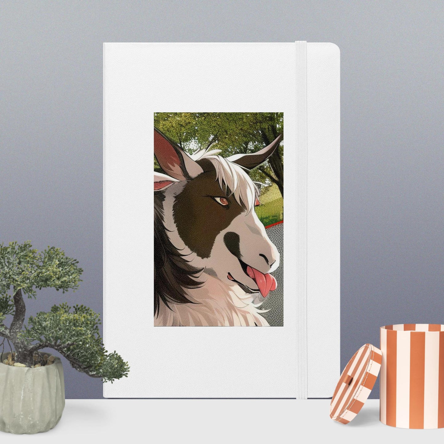 Hardcover bound notebook with goat cartoon with tongue out